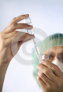 Woman doctor with syringe and medication