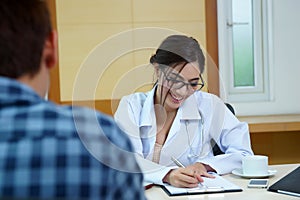 Woman doctor talking to her male patient at office