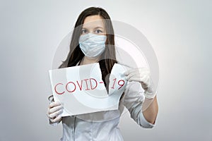 Woman doctor tear sheet virus covid-19 message coronavirus. Quarantine to fight corona virus pandemic