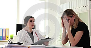 Woman doctor tells news about illness or shares poor treatment results during examination in clinic office
