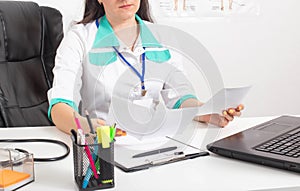 Woman doctor therapist looks and analyzes the results of examinations and analyzes. Human health concept