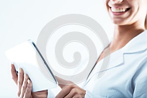 Woman is a doctor using a digital tablet