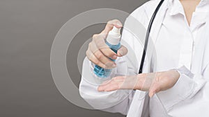 Woman doctor is using hand sanitizer