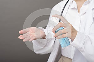 Woman doctor is using hand sanitizer
