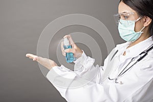 Woman doctor is using hand sanitizer