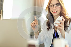 Woman doctor visit,telemedicine healthcare concept,young female doctor giving advice over laptop computer .she using laptop to get