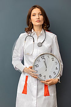 Woman doctor with a watch in her hands