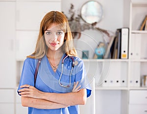 Woman doctor wear blue medical uniform and stethoscope look at camera posing in clinic