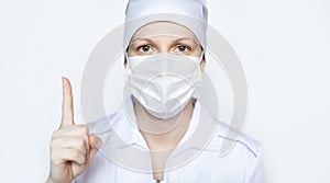 Woman doctor wearing protectiv mask showing thumbs up on white background