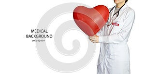 A woman doctor in a white coat with a large red heart in her hands.