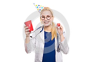 Woman doctor in white coat with party stuff