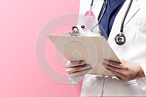 A woman doctor in a white lab coat with a pink ribbon and a stethoscope holding clipboard with a pink background