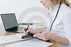 Woman doctor write in notepad, work at clinic