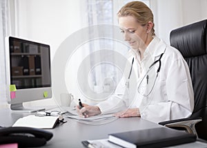 Woman Doctor Writing Findings at her Worktable