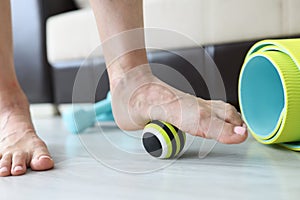 Woman does exercises with ball to correct foot defects and flat feet