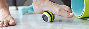 Woman does exercises with ball to correct foot defects and flat feet