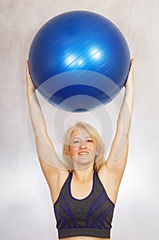 A woman does exercises from pilates at home