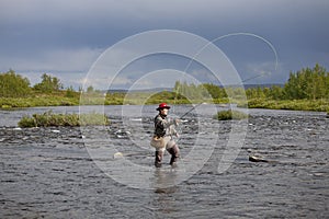 Woman does fly fishing in the river 1