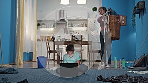 Woman does a housework and holds a basket of laundry.