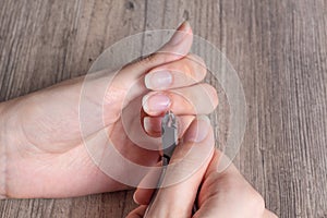 A woman does a manicure at home. Manicure tools. Edged manicure. Dangerous manicure. Home care, Spa, beauty. Nail salon