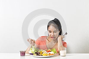 Woman does not like vegetable. Unhappy woman does not like healthy food