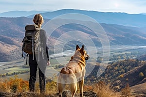 Woman and dog as they stand on the peak of a mountain. Generative AI