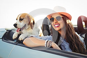 Woman and dog in car on summer travel