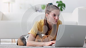 Woman with dog on floor browse internet, relax with gadget and cute pet beagle. Spbi 20s female