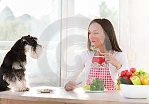 Woman and dog having lunch