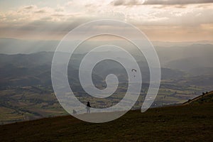 Woman, dog and paraglider