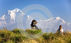 Woman and dog at Poon Hill in Himalayas photo
