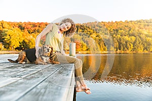 Woman and dog relaxing on the dock