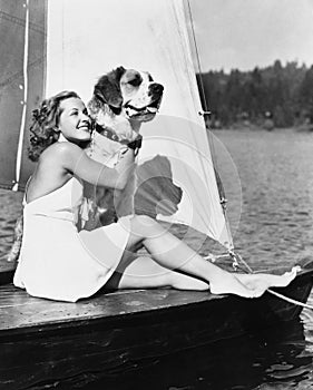 Woman and dog on sailboat