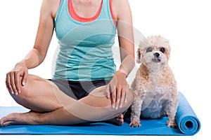 Woman and dog sitting on a yoga mat