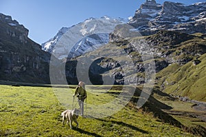 Woman with dog in Switzerland mountain valley Kiental