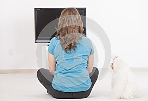 Woman and dog watching TV together