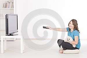Woman and dog watching TV together