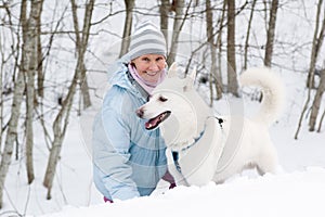 The woman with a dog in winter walk