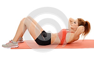 Woman doing abs crunches on a mat