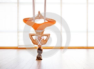 Woman doing of Aero yoga of antigravity in hammock