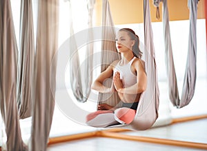 Woman doing of Aero yoga of antigravity in hammock