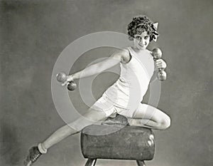 Woman doing arm exercises on vaulting horse