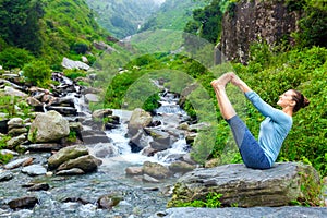 Woman doing Ashtanga Vinyasa Yoga asana outdoors