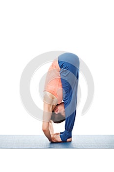 Woman doing Ashtanga Vinyasa Yoga asana Padahastasana