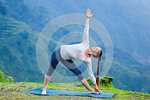 Woman doing Ashtanga Vinyasa yoga asana Utthita trikonasana