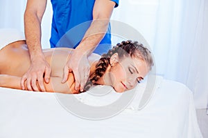 A woman doing a back massage in the Spa 1