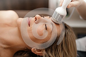Woman doing beauty therapy spa salon. Attachments device Hydra Facial skin care machine. Anti aging wrinkle deep clean