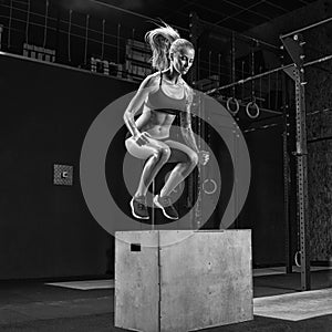 Woman doing a box jump at the gym