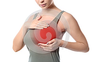 Woman doing breast self-examination on white background.