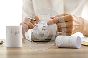 Woman doing calculations on an adding machine